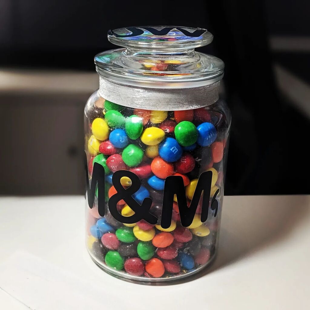 JayWll's tweet photo. A “celebration size” bag of M&amp;Ms fits perfectly in the jar in my office. That's a satisfying situation, but it's also new – a few months ago there'd be a good 20% left in the bag. #Shrinkflation 🍬 https://t.co/8UxNd98s6M https://t.co/Fv6WN9WGO4