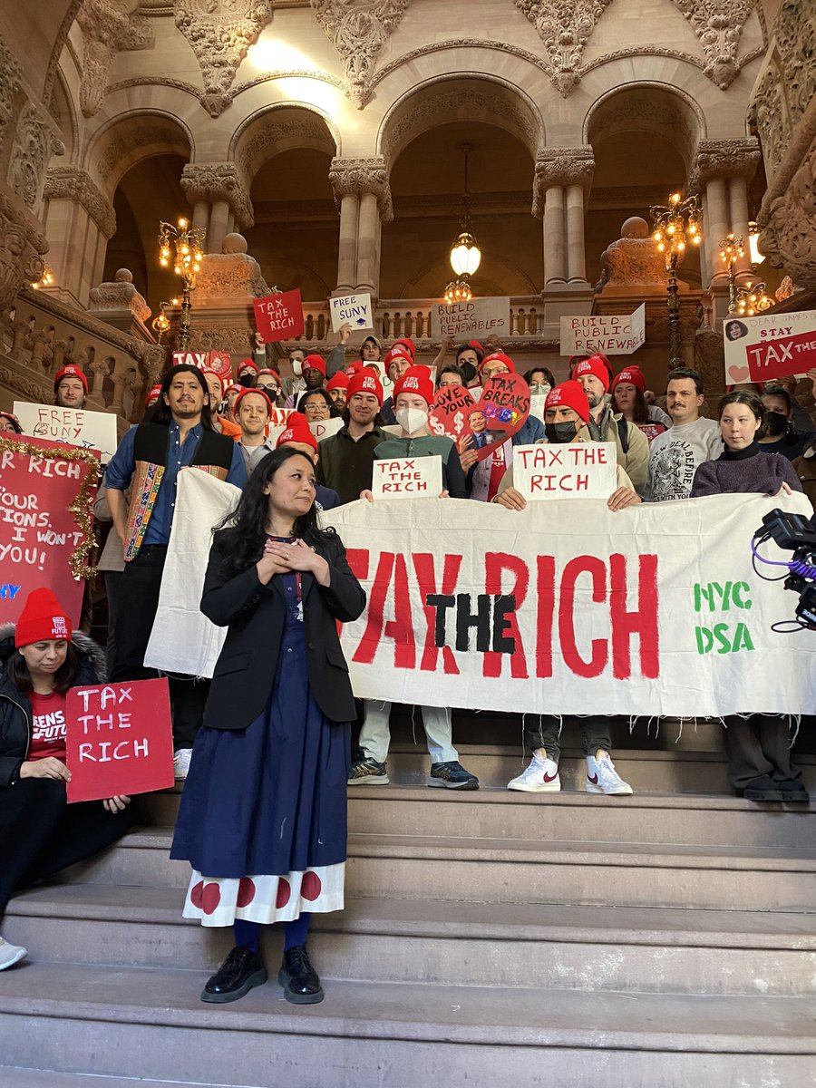 ZohranKMamdani's tweet photo. NYers are facing a cost of living crisis right now.

In the face of that, Gov. Hochul wants to hike the fare to $3 and increase tuition costs for CUNY &amp; SUNY.

We say no. 

It’s to make NY more affordable for the working class, and there’s three words for how.

Tax the Rich. https://t.co/f3p3kIwwRA