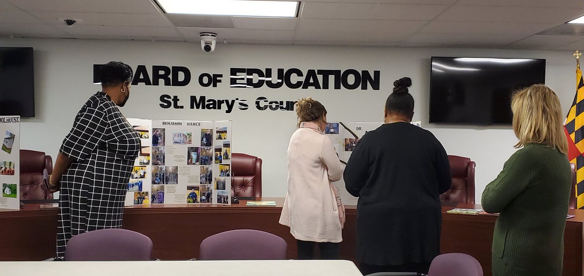 Equity School Site Leaders taking in a Gallery Walk of notable St. Mary's County African Americans.