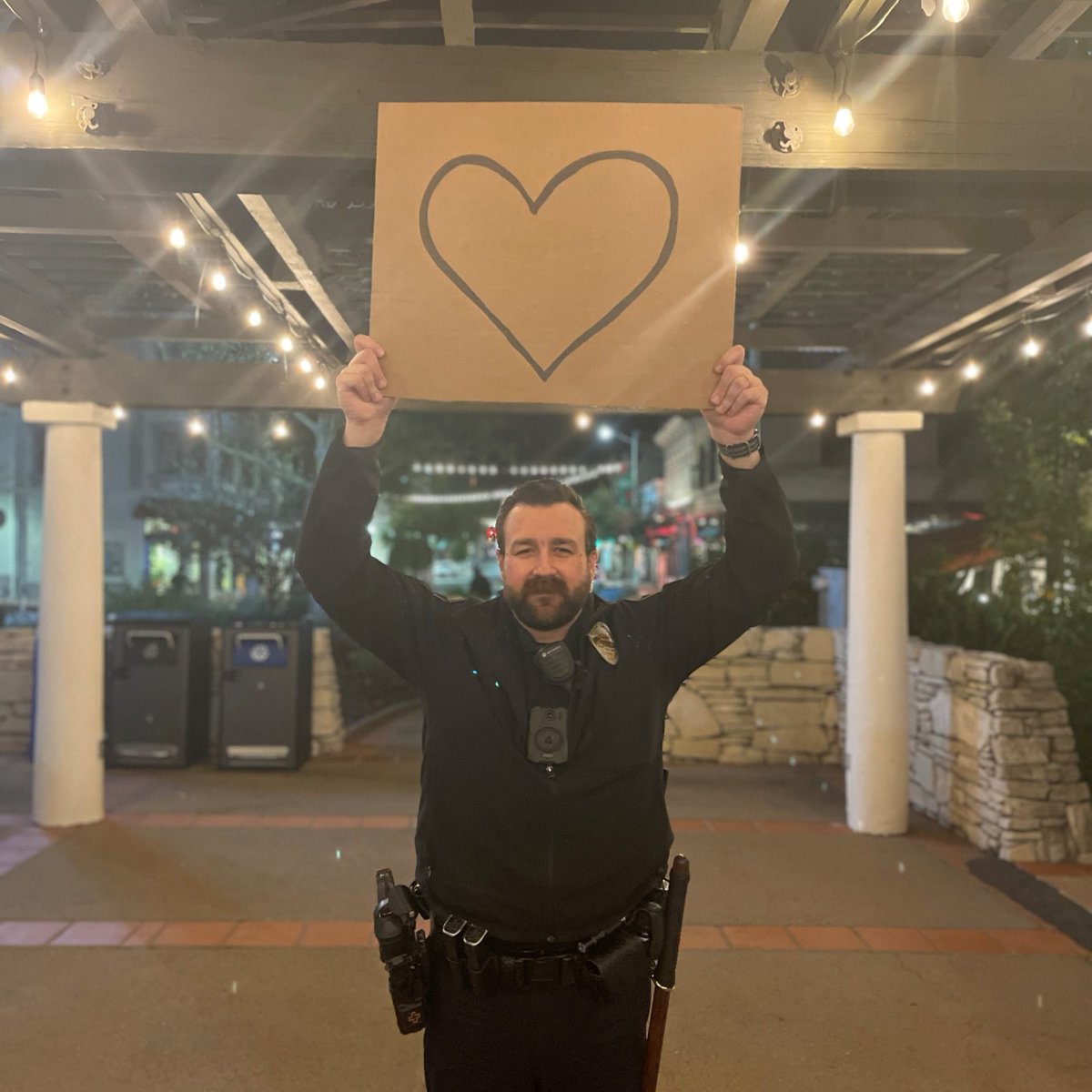 SLOCityPolice's tweet photo. Happy Valentine's Day SLO, we ❤️ you. #copwithasign https://t.co/fecJQtPhrK