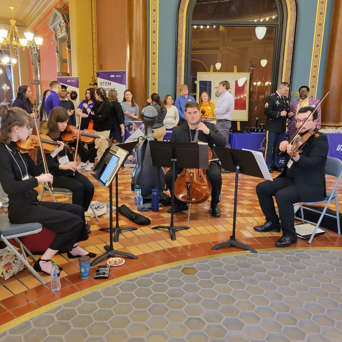 Our students are playing beautifully and representing the School of Music will at UNI Day at the Capitol in Des Moines today! TC and TK are big fans! #1UNI 💜💛🎶