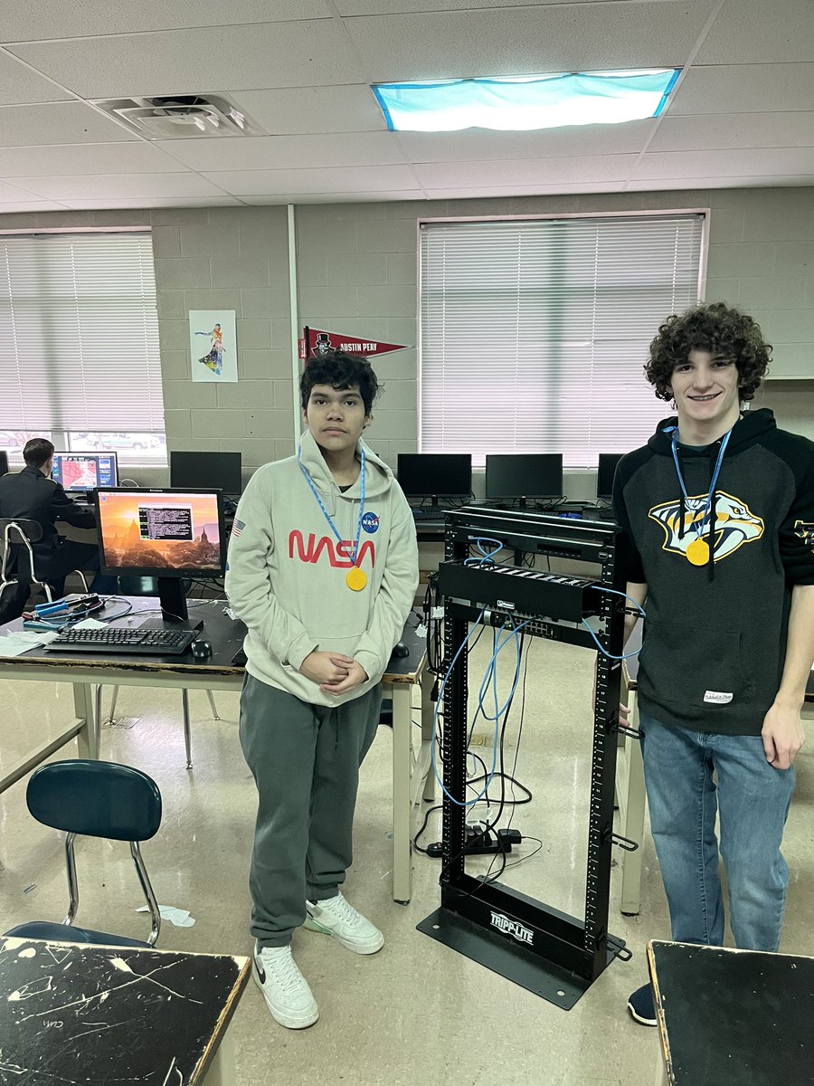Network rack build competition winners Bryan Canizales and Eli Abell. They worked hard and will enjoy their custom 3d printed medals.