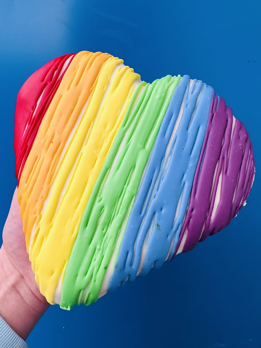 Indulge in a celebration of love and diversity with our Pride Love Heart Mega Doughnut! 🏳️‍🌈 Dipped in white chocolate fudge icing, it is then finished with a vibrant representation of the rainbow flag using multi-colored drizzles! 🤩 Available now on our website! 🥰
