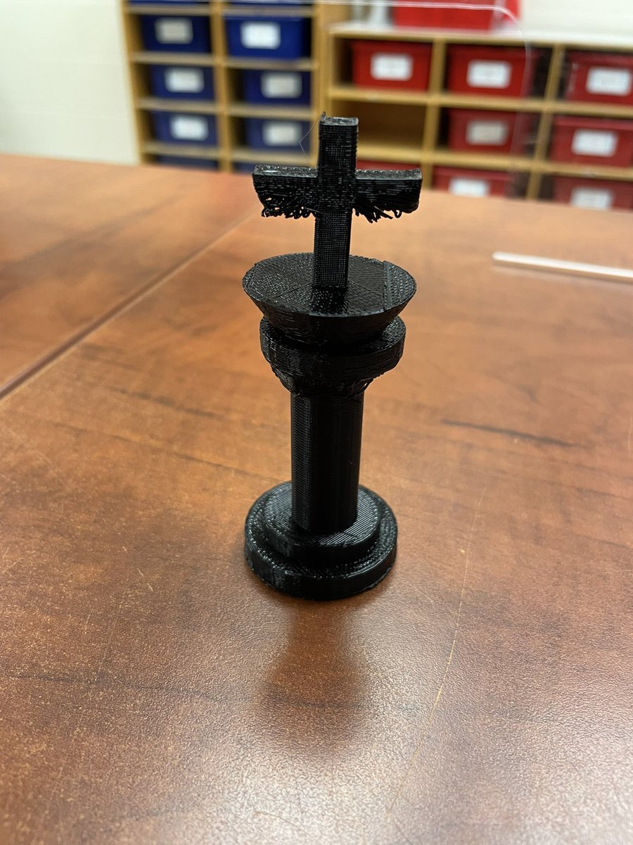 S was helping sort chess pieces for our games club and realized we were missing some of the kings - 3D printer to the rescue! This S measured the original piece to make sure the new one was the same size but added his own spin on the design. <a href="/StoneyBSharks/">StoneybrookSharks</a> <a href="/dtangred/">Derek Tangredi</a>