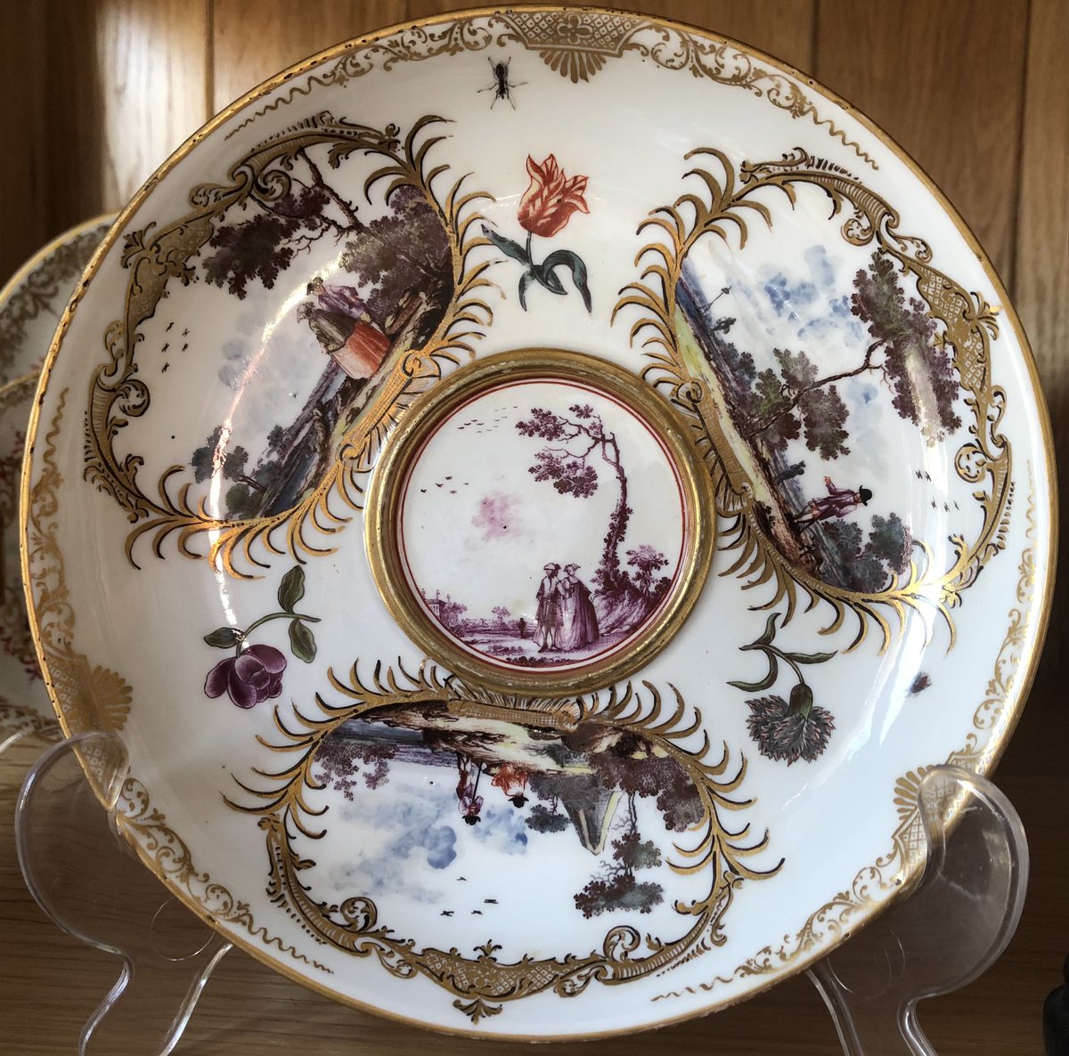 whitegoldsword's tweet photo. This is a #Meissen stand of around 17cm and was designed to support an #Ecuelle- a two-handled bowl and cover used for soup (see last photo as an example). The stand has three cartouches surrounded by golden fronds and containing scenes of men working and couples enjoying the https://t.co/1G3KJkTSnD