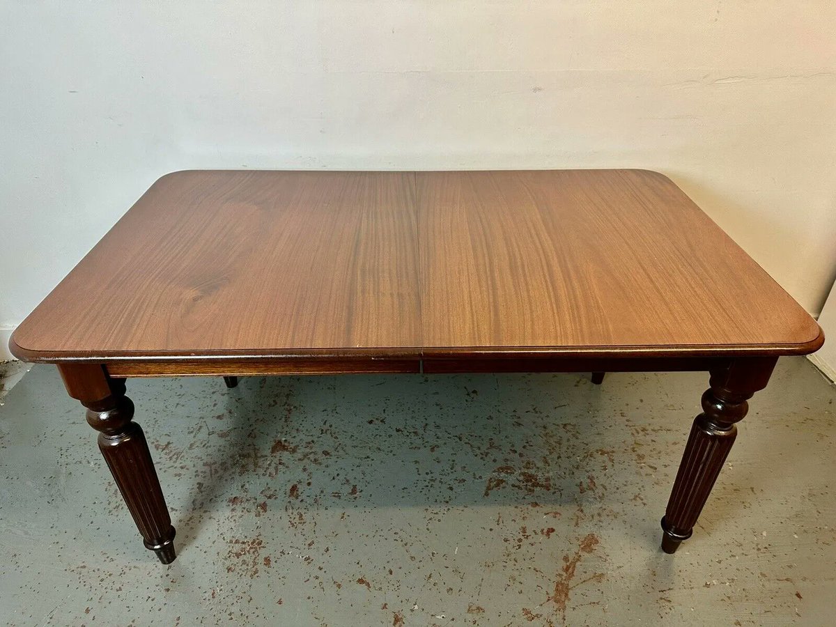A Beautiful 20th Century Georgian Style Mahogany Extending Dining Table. Made in England during later half of the 20th Century to a lovely standard. The large moulded edged top of rectangular with extending leaf with brass fasteners. 

#antiquesco #antiquefurniture #antiquetable