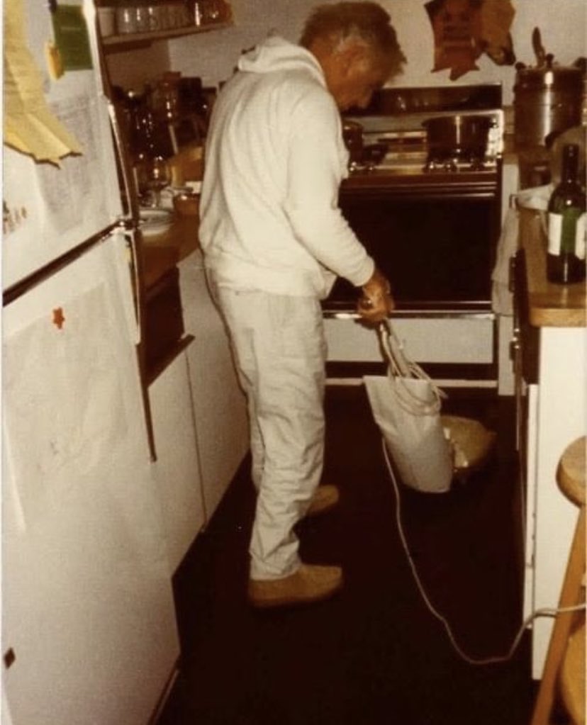 Leonard Bernstein vacuuming the kitchen.