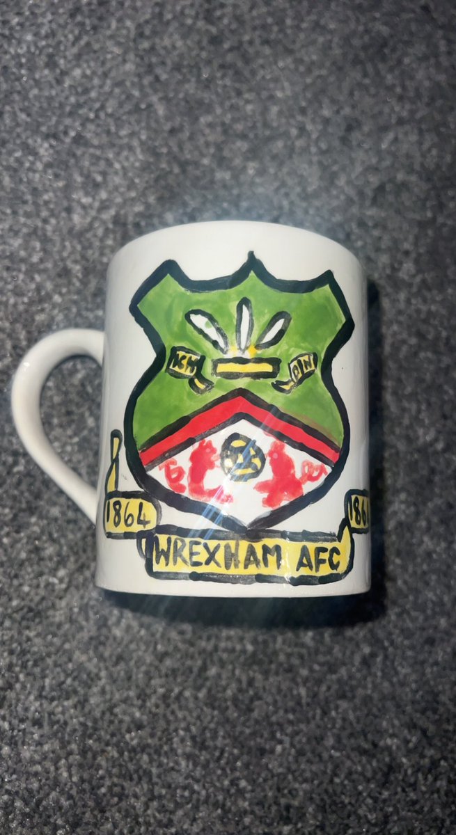MissSHEdwards's tweet photo. When your 6 year old son has bought everything from the Wrexham shop so decides to make a homemade Wrexham mug while enjoying a cookie and hot chocolate ☕️ ⚽️♥️ 

#WrexhamRetail #WrexhamMerch

@CwtchCeramics @Wrexham_AFC @RetailWAFC @VancityReynolds @RMcElhenney @WrexhamFX https://t.co/yl0nmYXrIC