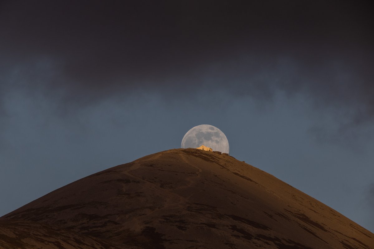 I've tried this photo before unsuccessfully. Finally this weekend the conditions were right to capture the #snowmoon rising behind the church on top of Croagh Patrick,Co Mayo #fullmoon #ireland #croaghpatrick