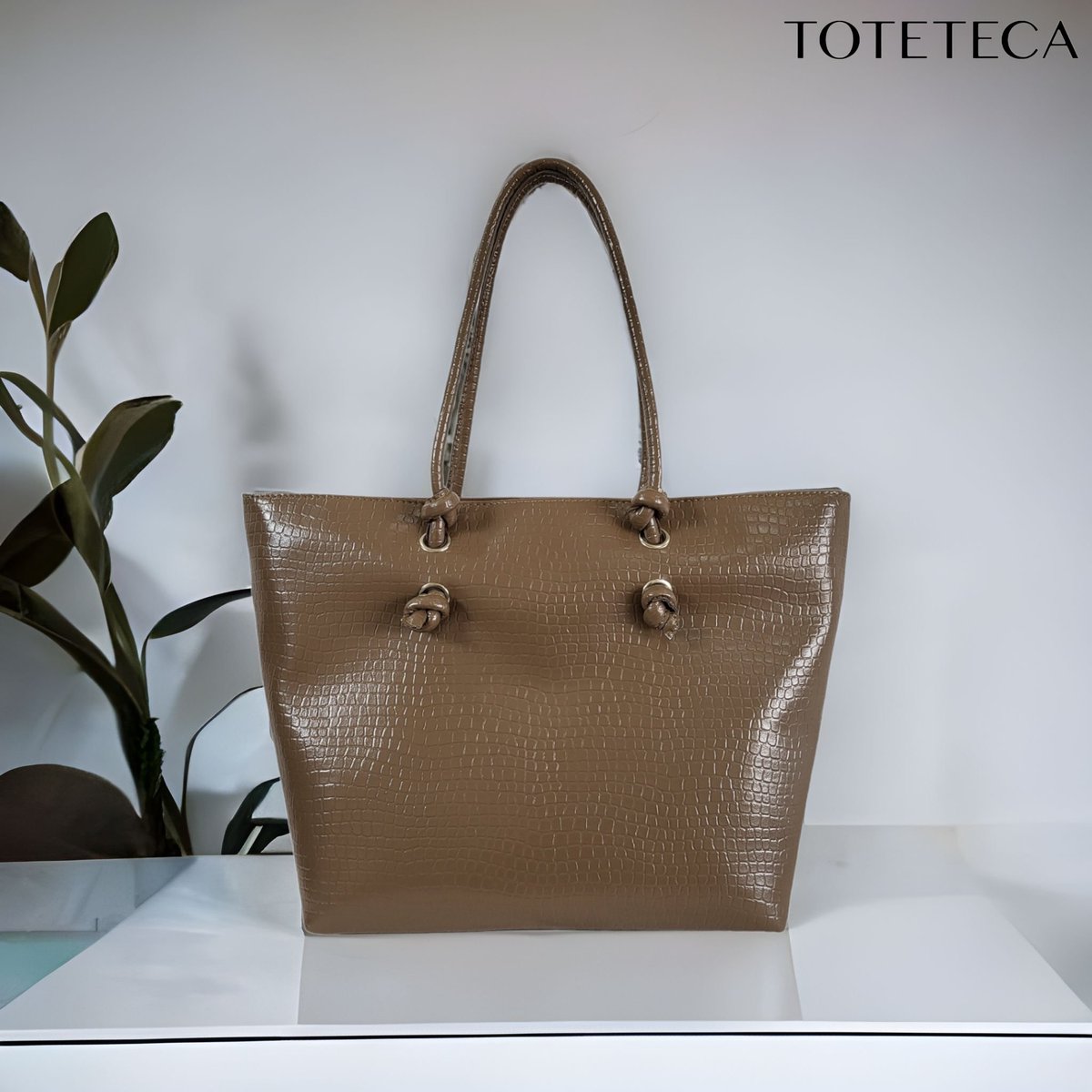 Exciting news! The new #knottedhandlecollection from #toteteca is coming in March 2023. This beige faux leather #crocodileskin bag is the epitome of minimal sophistication. Get ready to elevate your style! #fashionista #handbags #designerbags #luxuryfashion #baglove #accessorize
