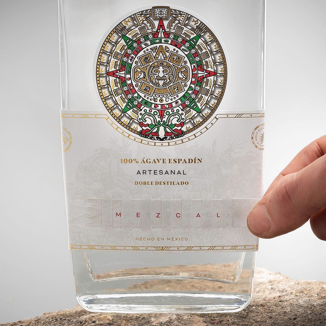 <a href="/JaviGardunoEdD/">Javier Garduño EdD</a>'s packaging for Azteca Mezcal. The concept is based on the Aztec calendar, represented on the label with 3 different papers printed with the Mexican flag colours. A pop-up system also allows to see the name of the product as you move it. #DailyDesignInspiration