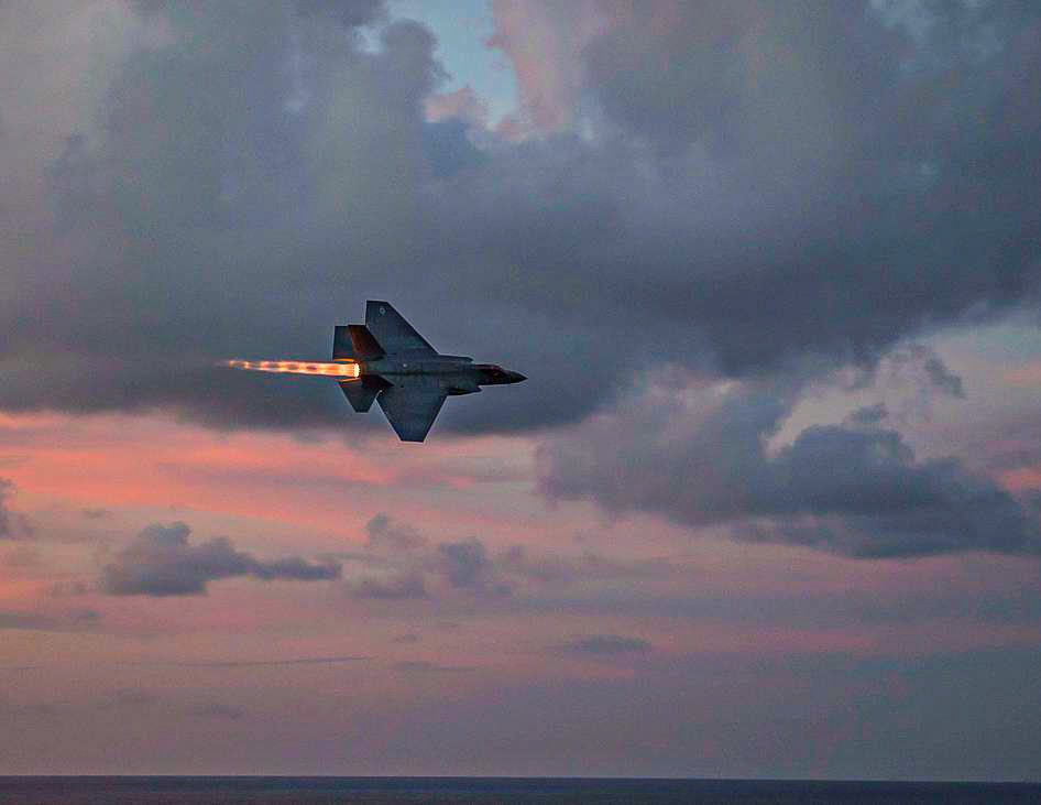 an F-35C Lightning II assigned to the Rough Raiders of VFA-125 above the Nimitz-class aircraft carrier USS Abraham Lincoln (CVN 72). (MCS Daniel E. Gheesling)