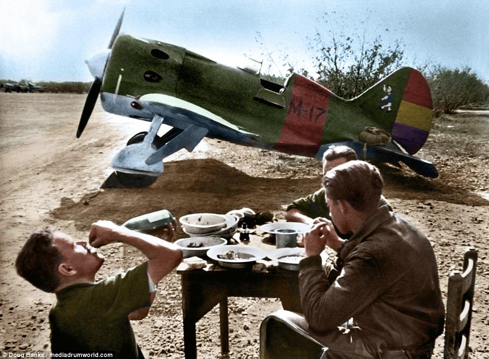 Civil_War_Spain's tweet photo. Republican mechanics having lunch in front of Soviet designed Polikarpov I-16 plane, nicknamed "mosca" at Els Monjos Aerodrome, Barcelona province, 1938. Rep colours +all-American proletarian hero Popeye painted on the tail. Original by David Seymour, colourised by Doug Banks. https://t.co/cWhldhWJHO