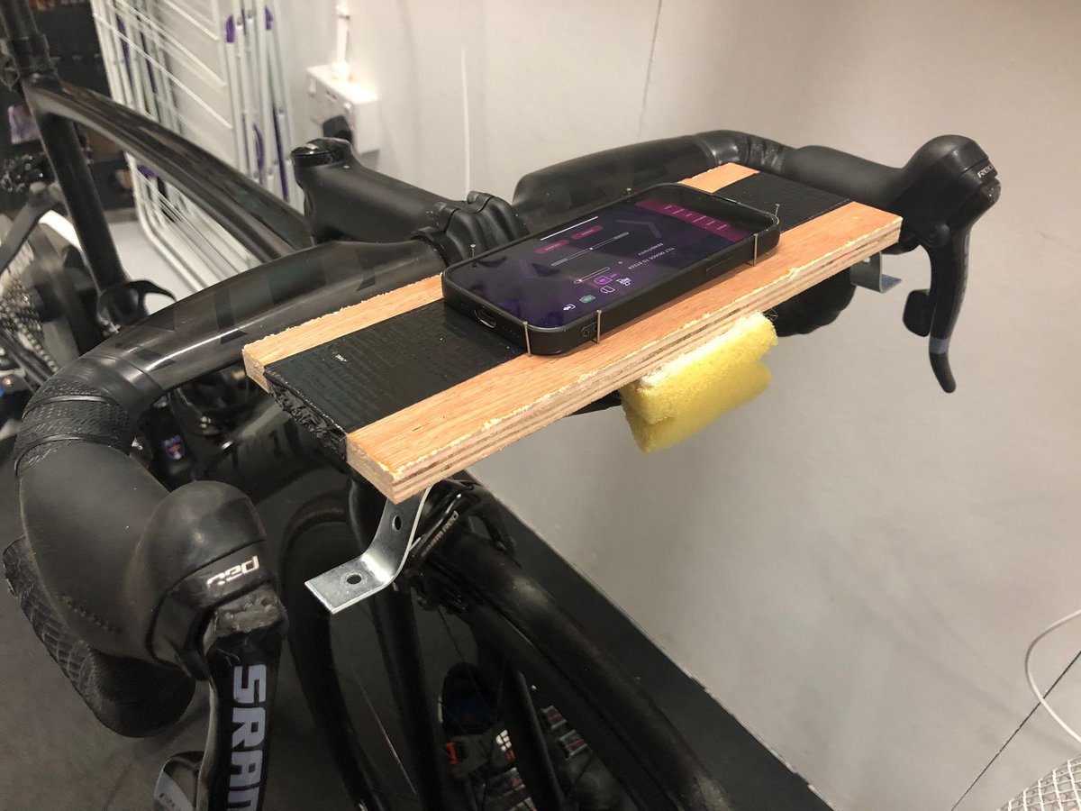 NickDart2's tweet photo. Saved myself £89.99 on the Wahoo RGT steering device. 
Bit of plywood + dishwashing sponge + duct taped to my out-front Garmin. https://t.co/OGrkjXCkr5