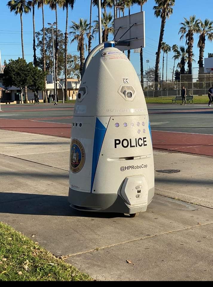 The Huntington Park city council meeting is being patrolled by municipal robocop.  Office bodycameras though are unaffordable.