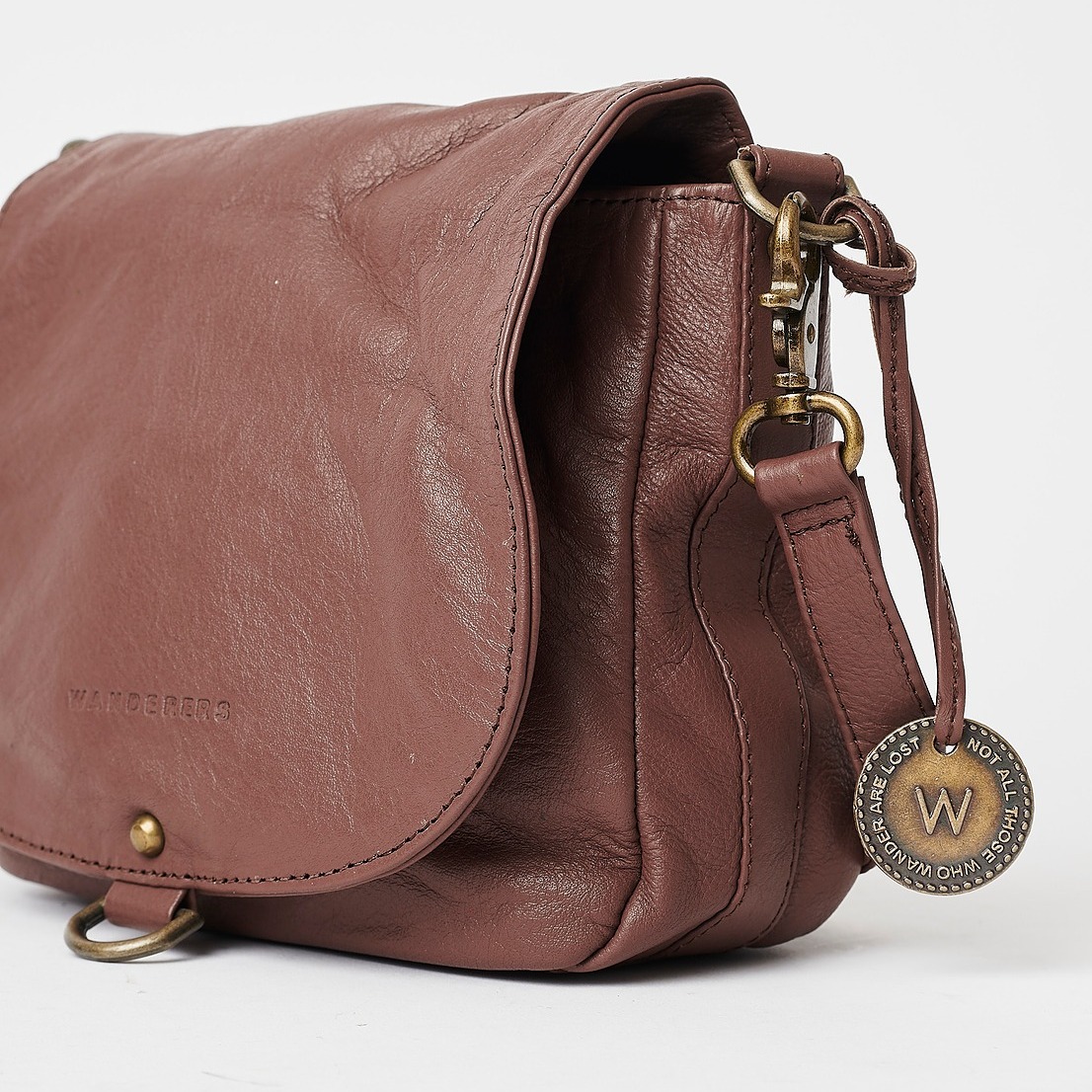 The SALZBURG Crossbody. With zippered internal pocket, flap closure, and our signature antique brass/copper detail, it's the perfect downsize for your essentials whilst Wandering!  Available online now at wandererstravelco.com