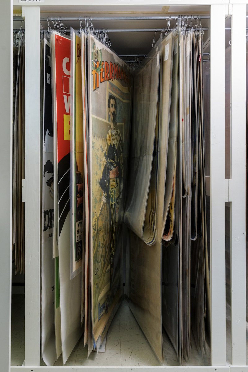 librarycongress's tweet photo. The hanging poster storage area in the Library's Prints and Photographs Division houses more than 100 super-oversize posters that are far too large to lay flat inside map case drawers. Some measure 9 feet tall. Others are 20 feet wide. 🧵 https://t.co/LmSFKpWiBi