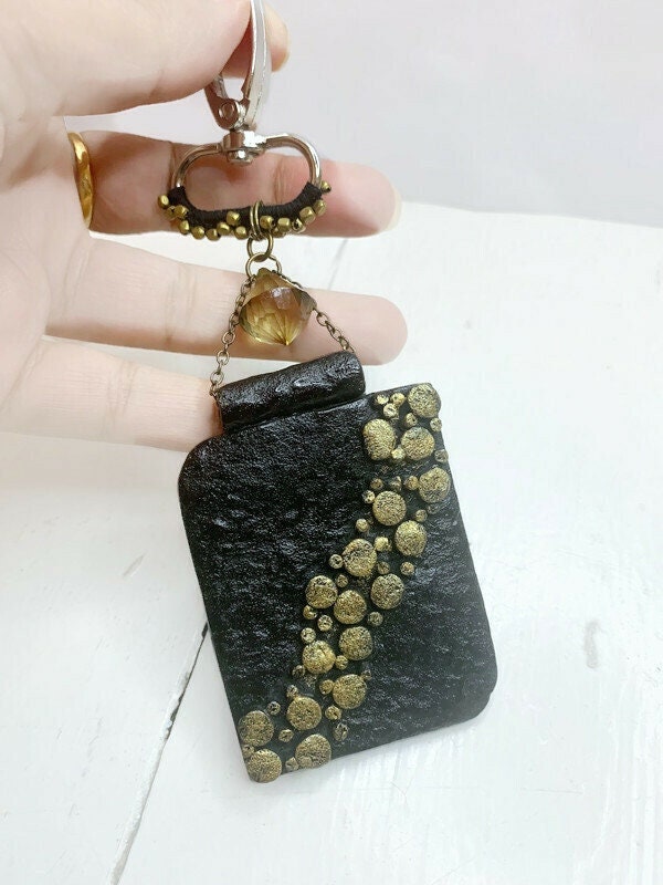 #etsy shop: Black rectangular purse charm, boho bag accessories, bag attachment, gift idea for her etsy.me/3JRgQyB #black #gold #vintagestylecharm #giftideaforwomen #tsvibrantcrafts #uniquegiftforher #bohoaccessories #