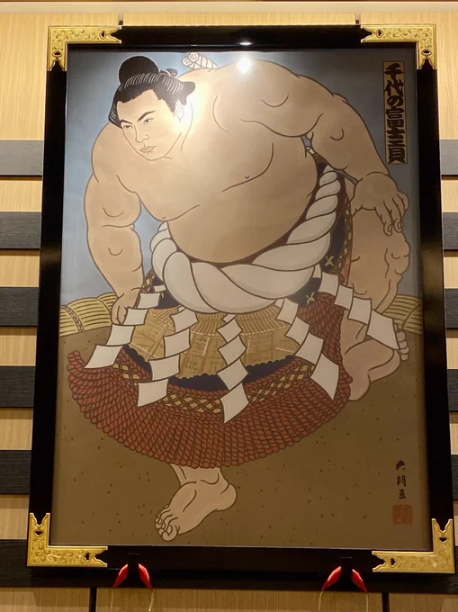 I'm having a hard time getting good photos without a glare on them but please appreciate all these handsome sumo portraits in our hotel lobby 