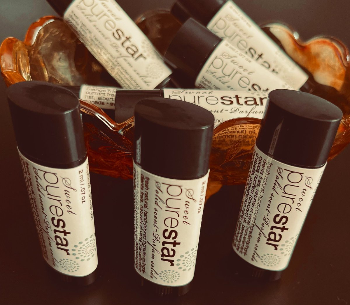 Back for a limited time only PURE STAR solid scent perfume stick.
4.5 grams of our signature scent perfume dark patchouli essential oil with hints of red currant, mango and vanilla notes blended in coconut oil and beeswax. Our mood shifter is famous for its intoxicating scent!$20