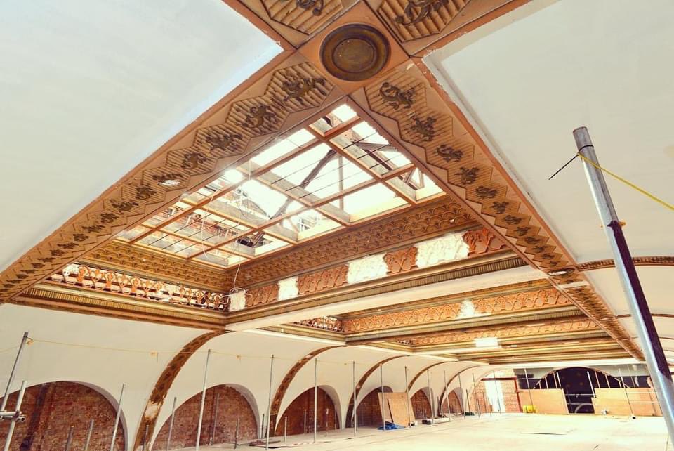 Bradford_Live's tweet photo. Fibrous plaster repairs and decorations being lovingly restored in the ballroom, beneath the temporary scaffold roof. @HeritageFundNOR @bradfordmdc @thenecgroup https://t.co/5DeyyYcqX1