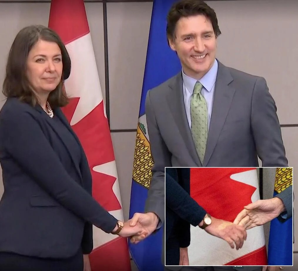 CoryBMorgan's tweet photo. Holy crap. 

You have to squeeze a person's hand pretty hard to leave an impression like that. 

Trudeau's loathing of strong women manifests itself in his enraged grip upon Premier Smith's hand. https://t.co/ycgFKwEuaE