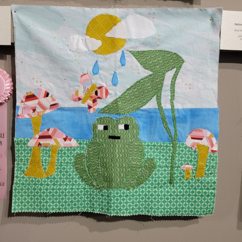 Hop into #WorldFrogDay with a couple of our #SchoolBlockChallenge entries!

“Into the Forest” by Victoria Paige, IN
5-8 Grade Category

“Nelson’s Beautiful Day” by Ariel Reyes &amp; Rebecca Soe, TX
9-12 Grade Category

#youthart #frog #quilting #quiltart #art #quiltblock