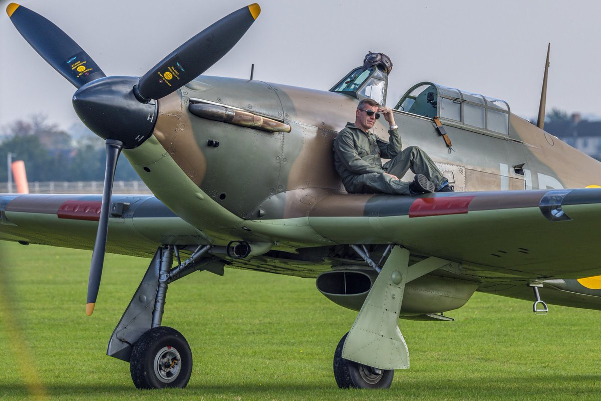ShutterbugWGC's tweet photo. Hawkers Hurricane Week:

One of my favourite pictures of R4118 shows her owner James Brown as some other fighters are starting up and taxying at Duxford’s Flying Day: Best of 2021…I wonder what he’s thinking….?⁦@HurricaneR4118⁩ ⁦@Ultimate_Aeros⁩ #AvGeek #FlyingDays https://t.co/SJuNrPJTc6