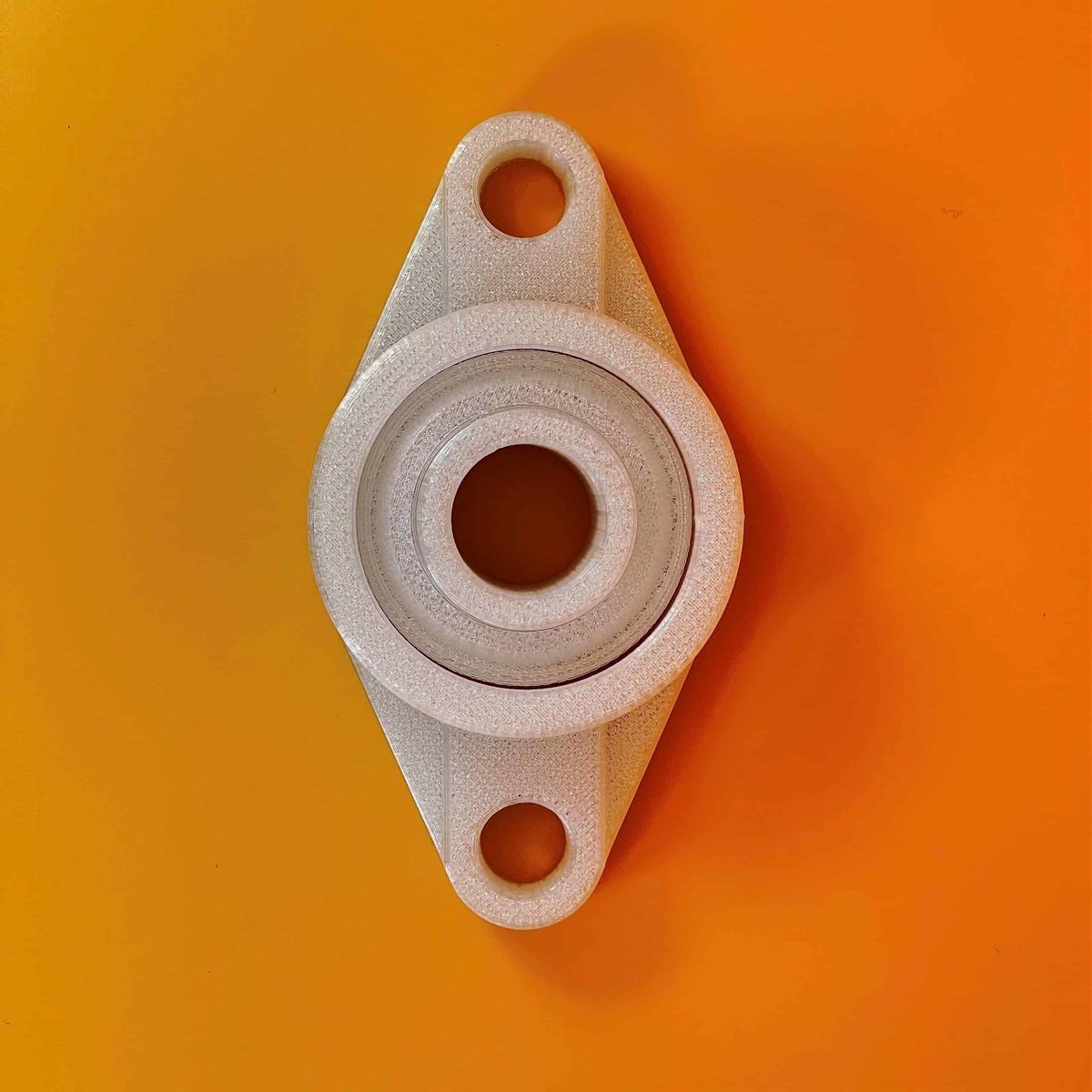 EDGE Sample 3D print: UCFL 2-Hole Pillow Block Bearing Flange in Polycarbonate. 4mm print tube (nozzle), standard print settings (200 micron layers). Total print time: 5h 58min. More pictures &amp; details: bit.ly/3xIAIfR