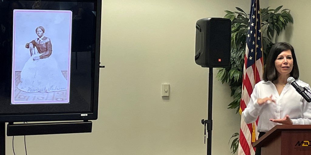 MarylandDOT's tweet photo. At MDOT’s #BlackHistoryMonth event, Dr. Julie Schablitsky, chief of cultural resources, discussed the new archaeology lab at HQ & recent discoveries, such as the home of Harriet Tubman’s father, Ben Ross. Initially, she said it was like “finding a needle in a haystack.” #MDOTdigs https://t.co/9kP3kwQqJX