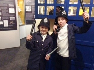 Some of our young visitors dress up in the Police Box to show us how to deal with the Mayhem of the current exhibition Murder, Mayhem and Mystery. Complete with helmets and squeaky truncheons! Come and visit us and wear
a mustache as well if you fancy.