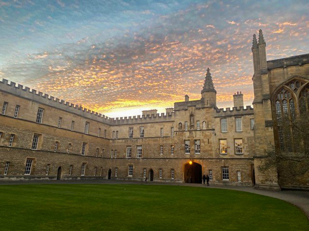 A sunset with lots of small clouds over a gothic building