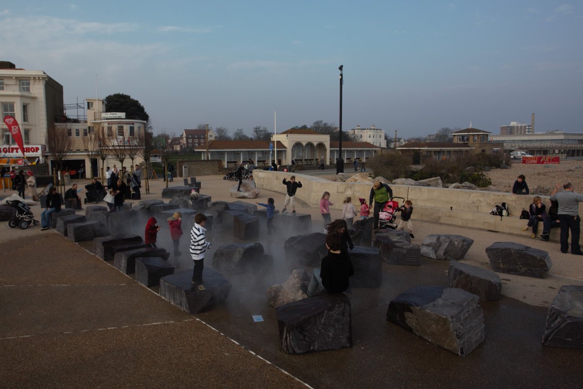 Ustigate's tweet photo. In 2010 Ustigate installed John Pegg's vision for Worthing seafront - a beautiful misting water feature, set amongst welsh slate boulders. In 2023 Ustigate returned to install a colour changing LED system #worthing #splashpoint Full case study here: https://t.co/gmTAYDLL50 https://t.co/E2SeqK7jB3