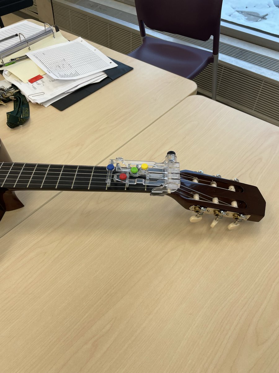 This transparent guitar buddy helps those who have difficulty playing chords with their hands. You can simply click the button and use another hand to play strings, instead of pressing strings while playing it. #makeinclusivemusic