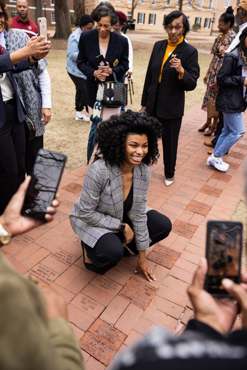 UofSC's tweet photo. Student leaders, student-athletes, student activists and student advocates. Gamecocks one and all.
 
Today was a beautiful day to unveil commemorative bricks on the Horseshoe to honor 20 Black alumnae who have made indelible marks on our university. 🧱 #BlackHistoryMonth #BHM https://t.co/aj9tbQvyJp