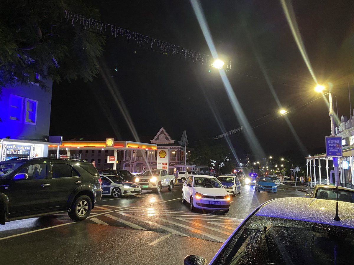 ewnreporter's tweet photo. This is the crime scene where rapper @akaworldwide was shot and killed, alongside his protector. Their bodies have not yet been removed from the scene but are covered with two table umbrellas. #Aka @_NMabaso https://t.co/aEYj0XediZ