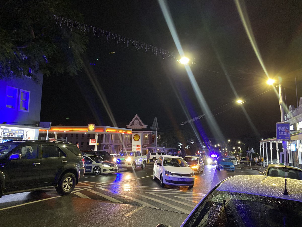 ewnreporter's tweet photo. This is the crime scene where rapper @akaworldwide was shot and killed, alongside his protector. Their bodies have not yet been removed from the scene but are covered with two table umbrellas. #Aka @_NMabaso https://t.co/aEYj0XediZ