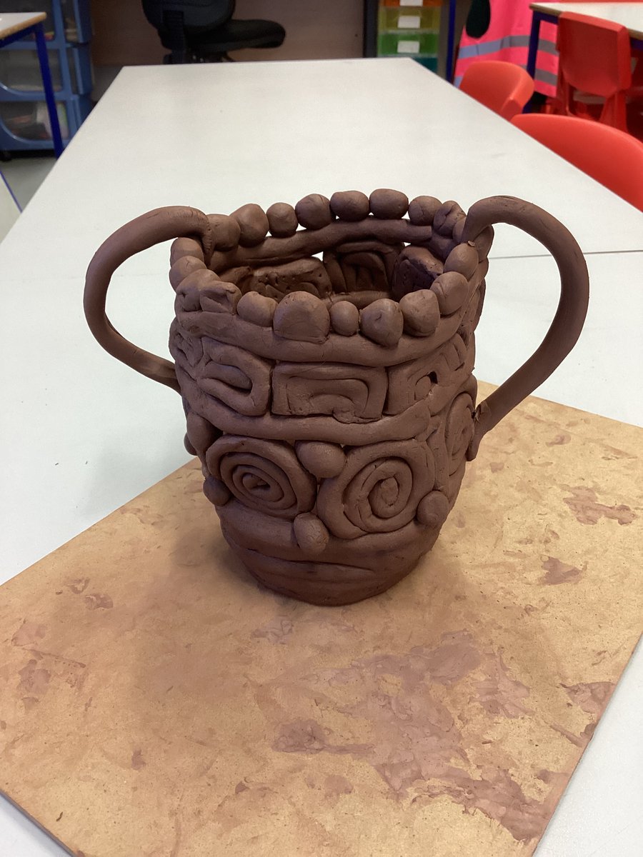 GoldthornPark's tweet photo. In Art this week, Class 8 have been experimenting with clay and testing out different coil motifs ready for next week when they will be making their own coil pots. We used the coils from the lesson to make a class pot. What do you think? #AthethsvSparta #Dimensionscurriculum https://t.co/zpBVWlisQB