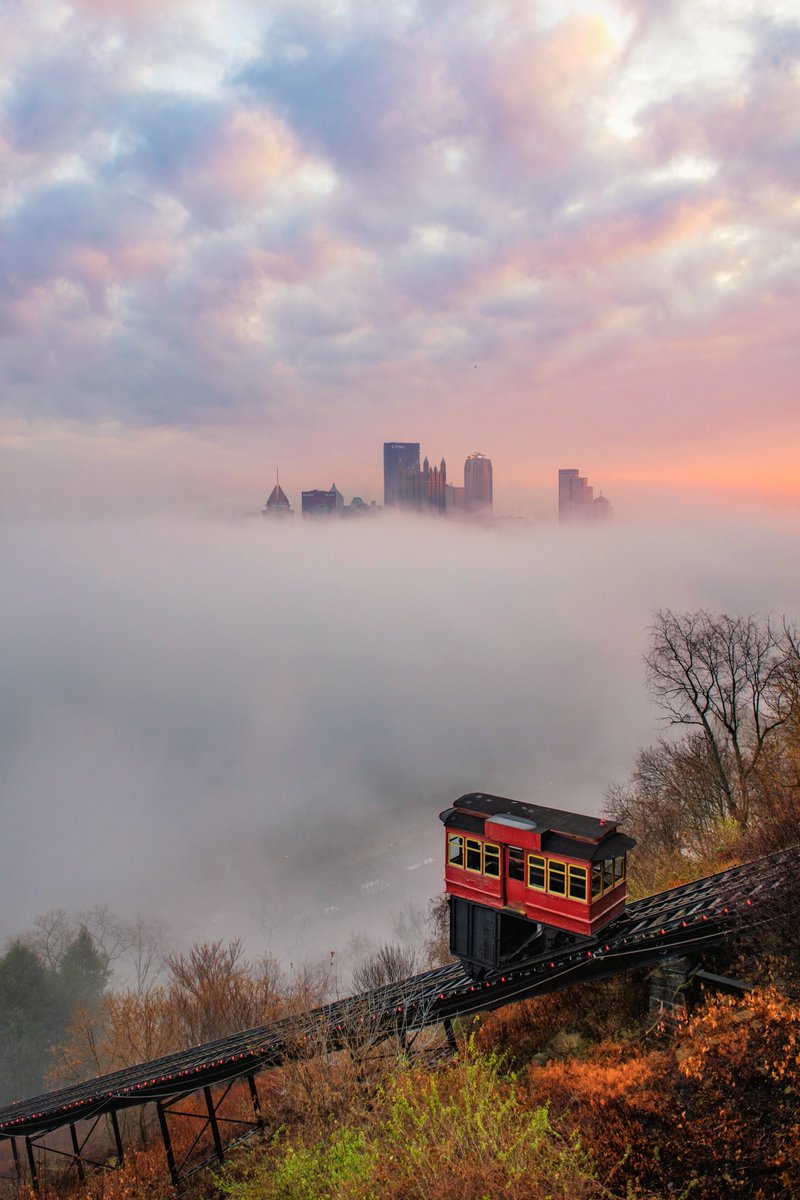 DaveDiCello's tweet photo. Getting a colorful sunrise like this one on a foggy morning in #Pittsburgh is pretty rare, but when it happens it makes for some incredible views. I haven't spent a lot of time on the incline since we haven't had a lot of snow, and I do miss capturing the city from there. https://t.co/SkutliuhdL