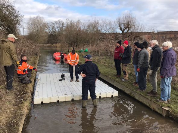 GoringGapBC's tweet photo. The new pontoons have arrived https://t.co/2men1YenNQ

A set of new to us, but preloved pontoons have arrived. The men in orange are showing our team of volunteers how to fit them together – apparently it’s just like Lego! We will need a few work parties to get our pontoon swap… https://t.co/C9BF8xcqQm