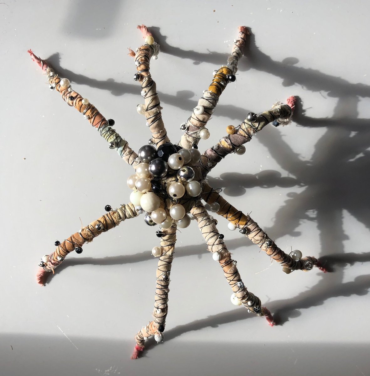 The top-side view of my Arachnid baby. 

.. 

#spider #dramaticlighting #textileart #beads #mixedmediasculpture #spiderdoll