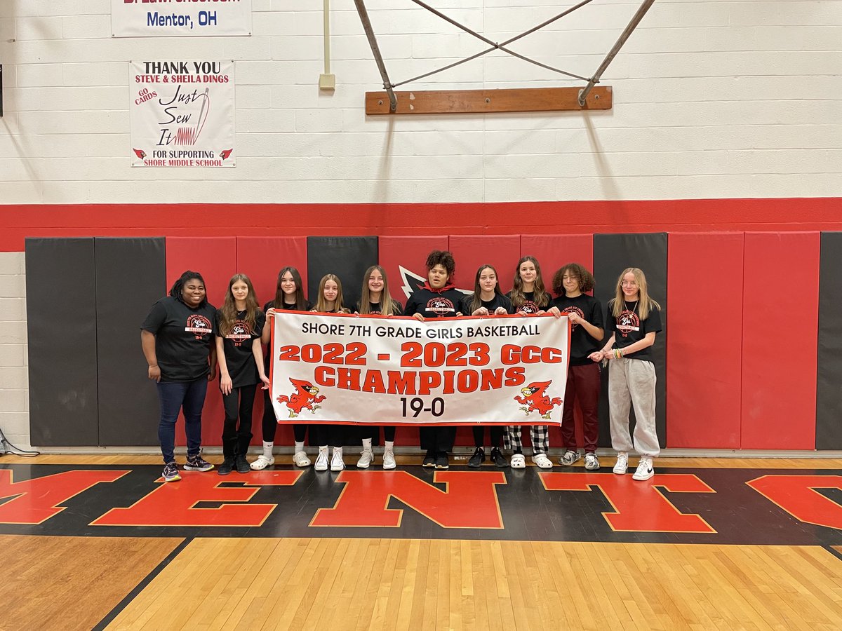 7th grade girls basketball get their gym banner and championship t-shirts. A perfect season, 19-0.