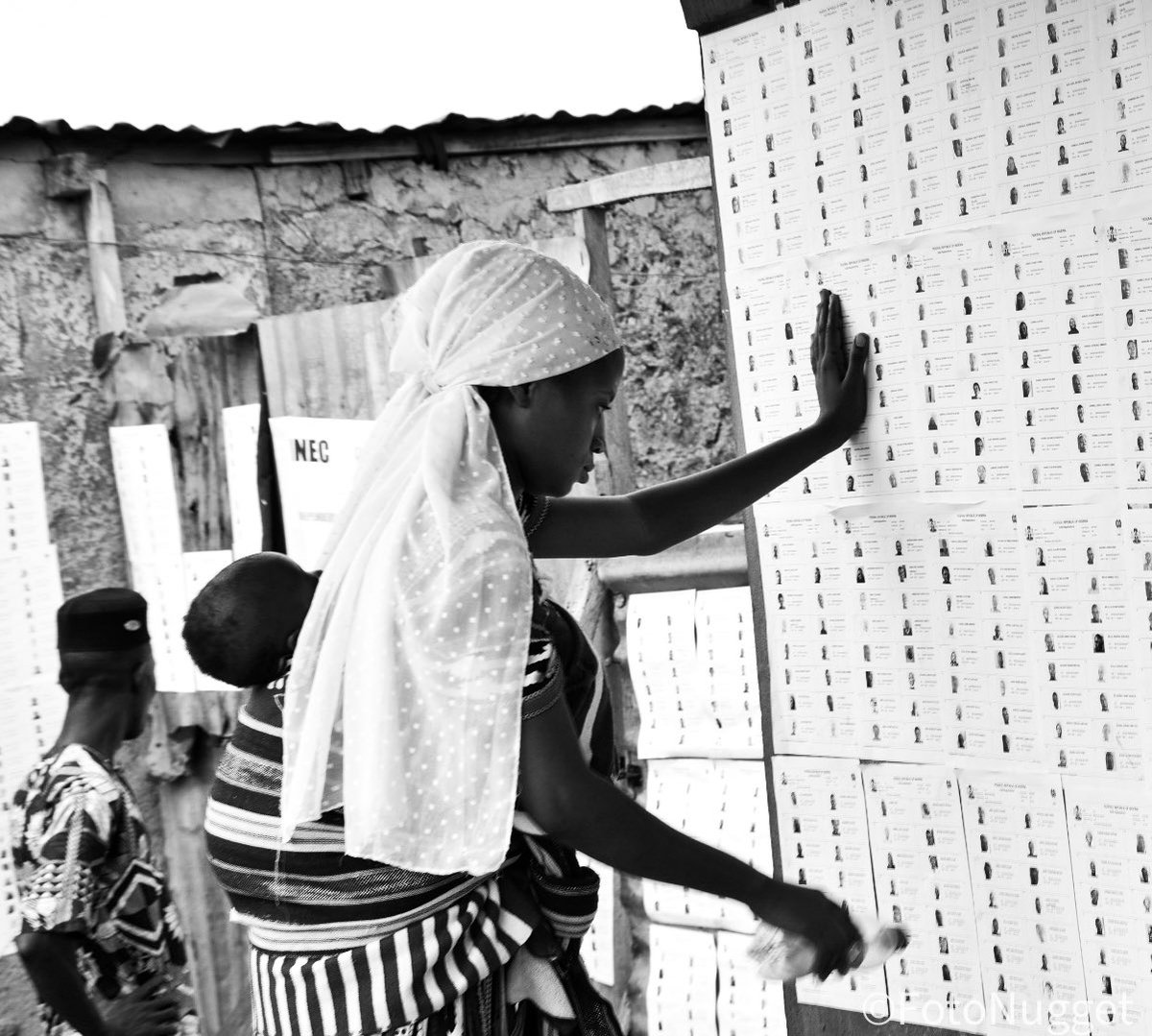 A mother backing her child whilst undergoing through the accreditation process before casting her vote in Ibadan South West, Nigeria.

#CDDEAC #NigeriaDecides2023 #CDDWestAfrica