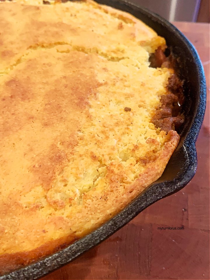 This Corn Bread Chili Pie is not picture perfect but like us, it doesn’t have to be.  It’s a delicious chili cornbread casserole that is baked with love and filled with comfort. #CastIronSkillet #FamilyRecipe 
My Aunt Erma's Recipe>> myturnforus.com/corn-pone-pie/