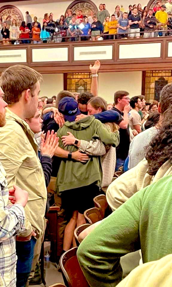 #asburyrevival TESTIMONY “This is what happens in revival. Pic I took Thur night in Hughes at Asbury. The student in the middle was just saved. His friends embraced him for a long time. Heaven did too. Many many more also stood to confess their faith in Christ.” @belliff