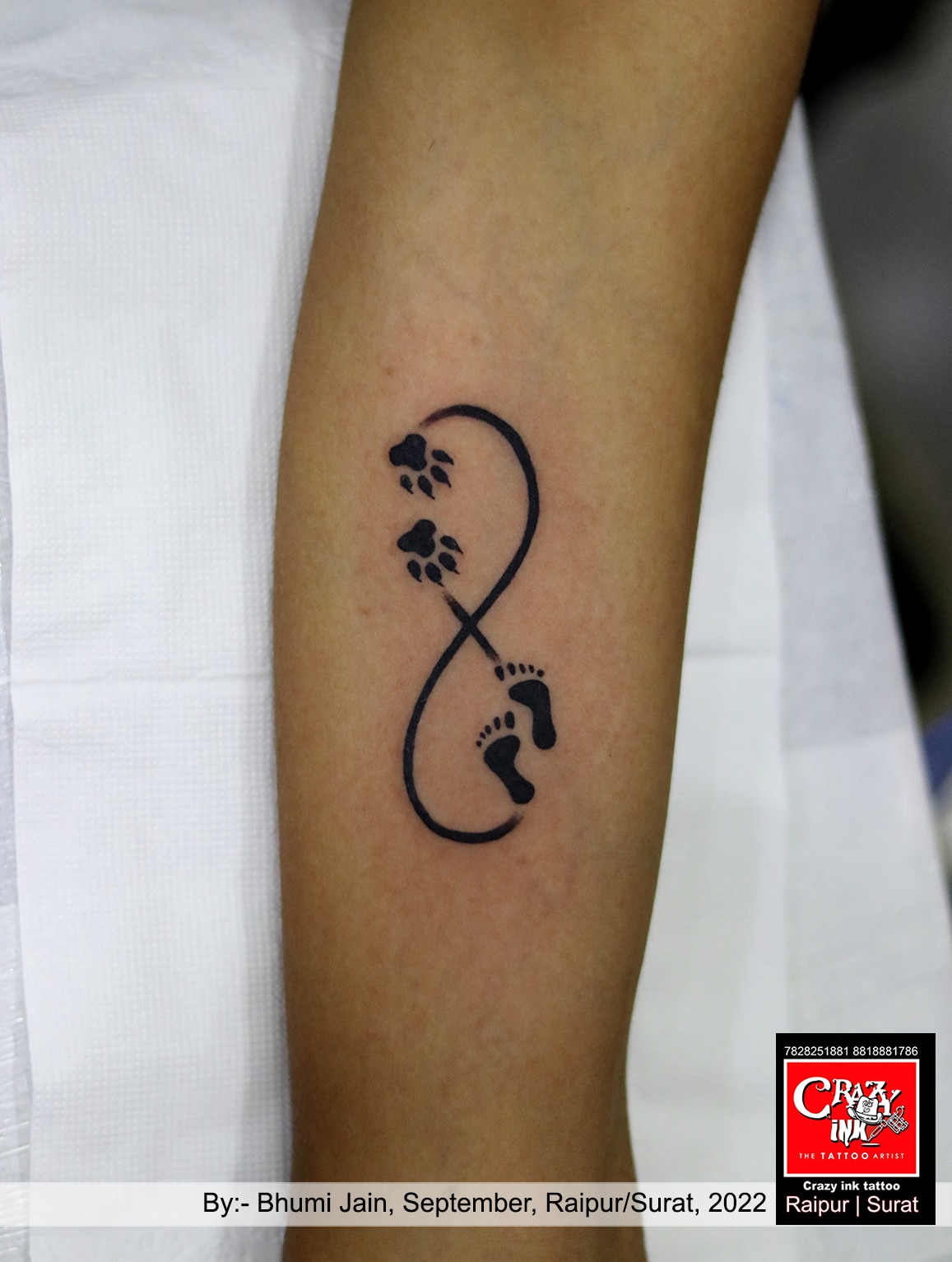 Infinity symbol tattoo done in white ink, located on