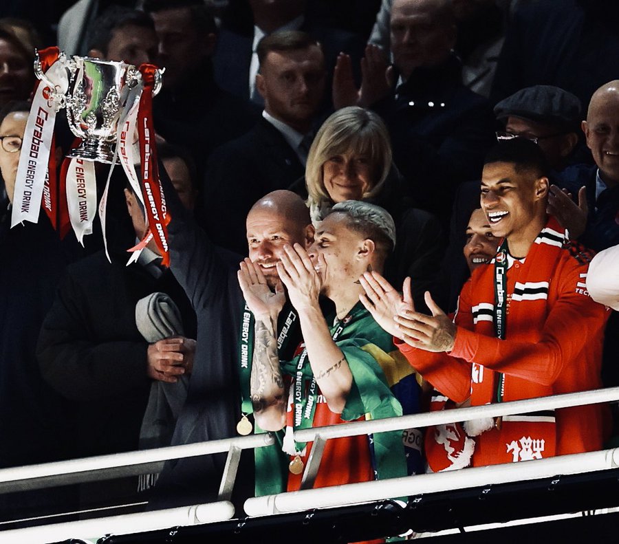 Erik ten Hag lifts the Carabao Cup alongside Antony and Marcus Rashford.
