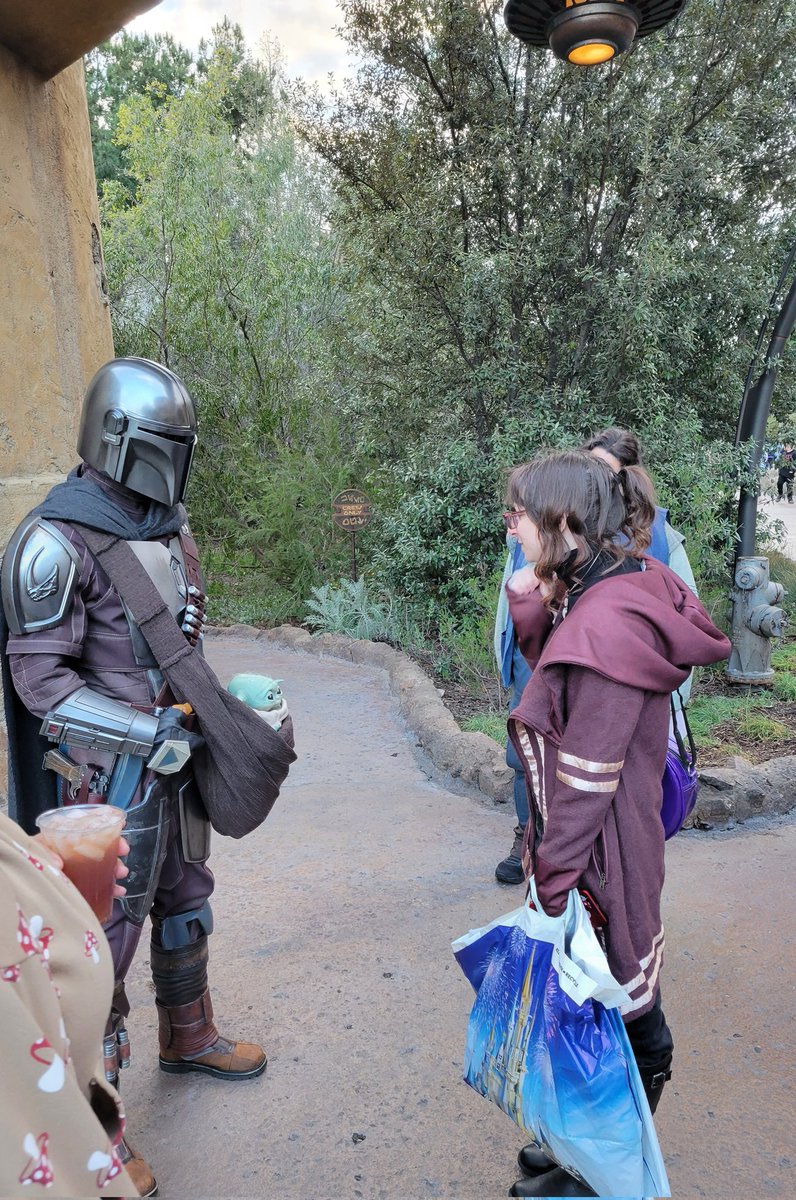 FairyoftheDead's tweet image. Din approached me today and I am still smiling 4 hours later. Nearly cried when I noticed Grogu and it sounded like he said "I love you."  
Din: You look nervous. Are you on the run?
Me: Yes running towards *smirk* 

#swge #DinDjarin
#grogu #Mandalorian #Disneyland