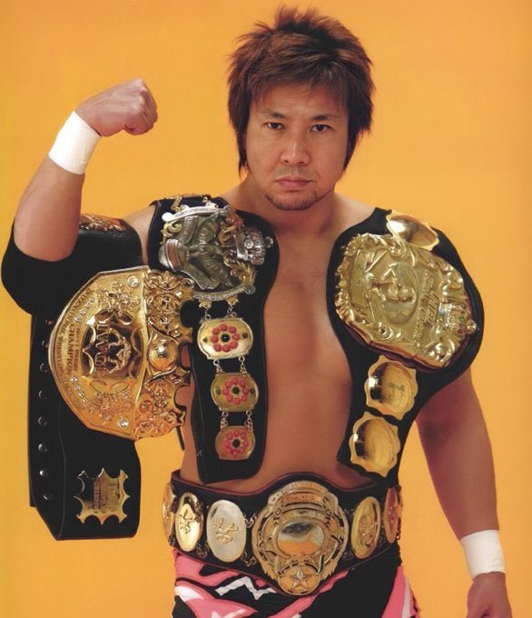 Satoshi Kojima With the IWGP Heavyweight Championship and The Triple Crown Heavyweight Championship. Circa 2005.