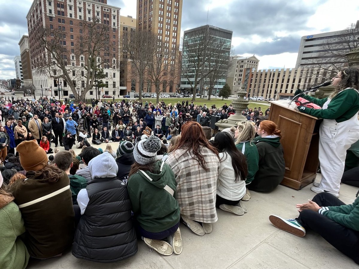 Simon_Schuster's tweet photo. The legislators were asked by Maya Manuel, one of the protest organizers, to sit in the front of the crowd and see the grief-stricken faces of the MSU students in attendance. https://t.co/IJ9QVa6Oh0